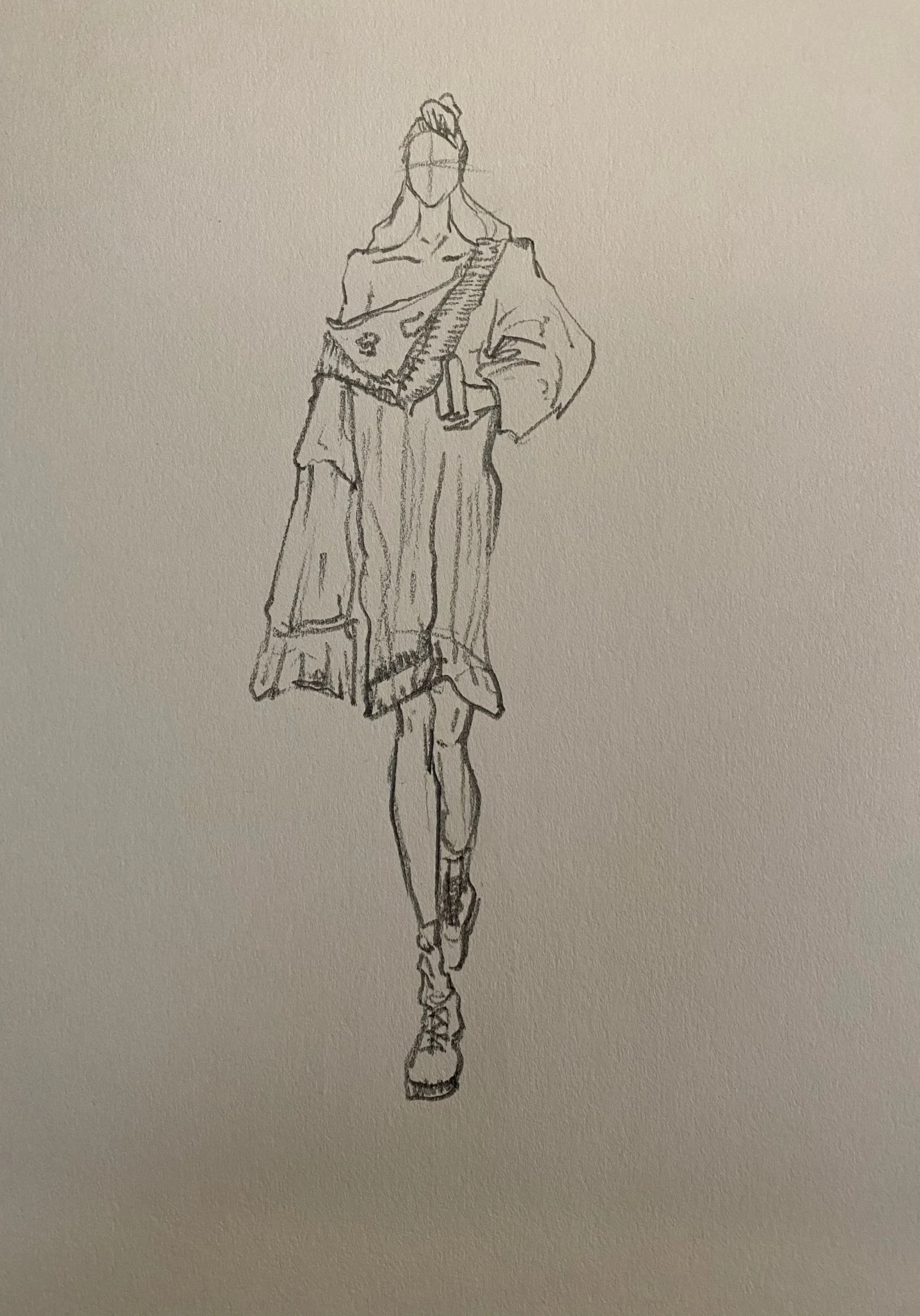 Pencil sketch of a fashion figure with layered garments.