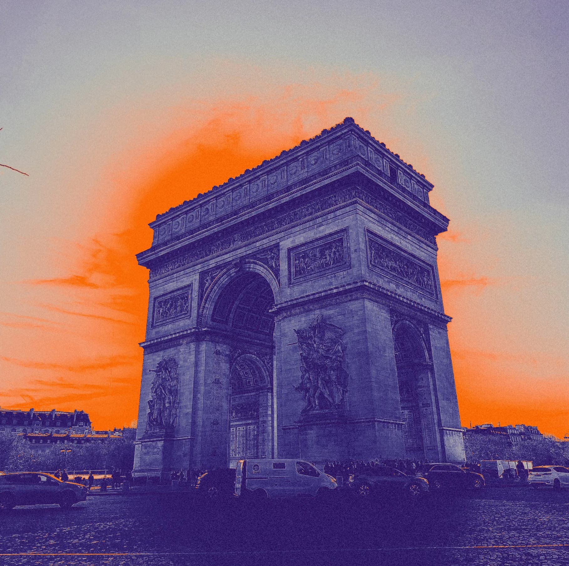 An arch monument in purple against an orange sky.