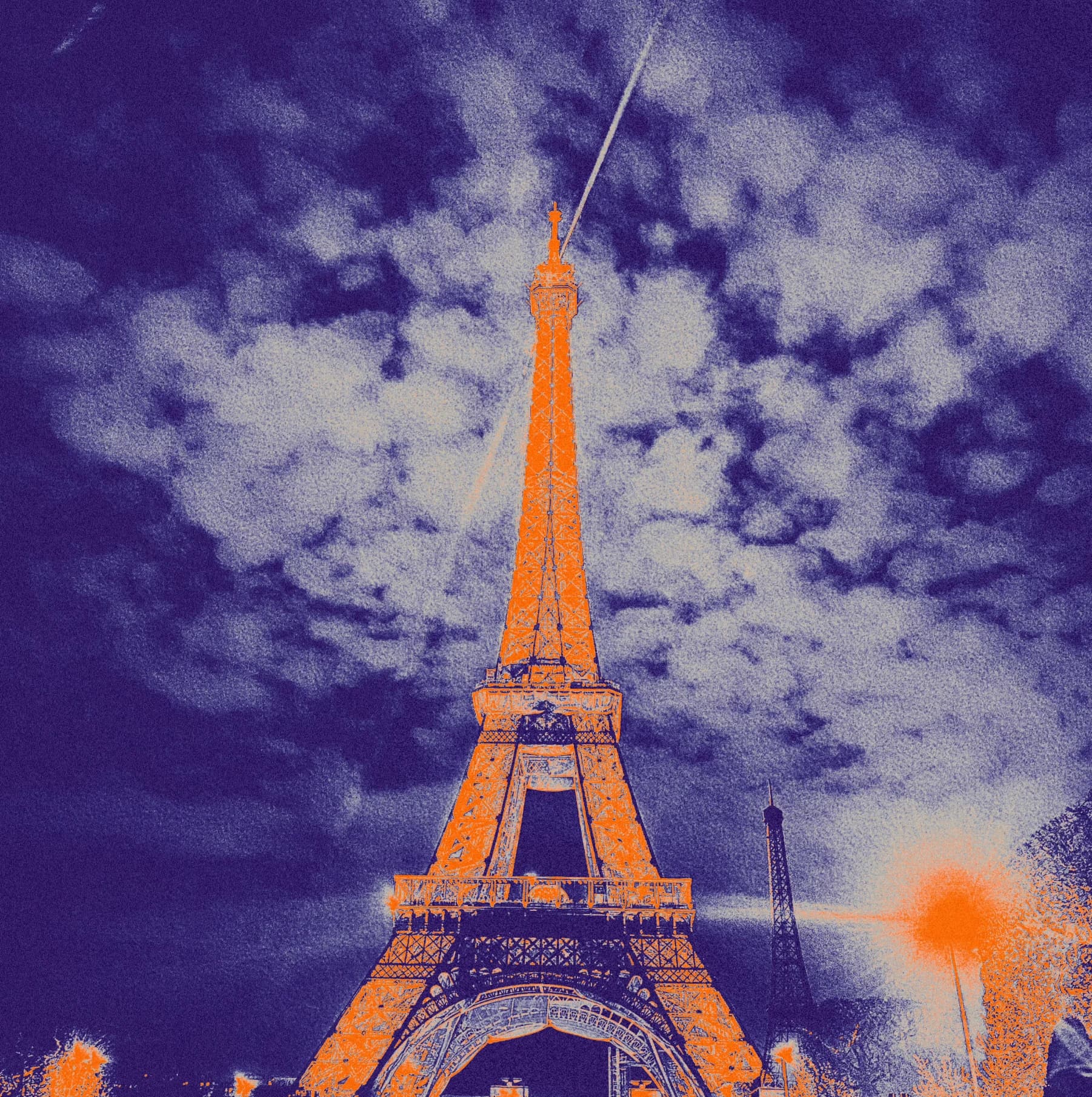 Tower rising into a purple sky with white clouds.