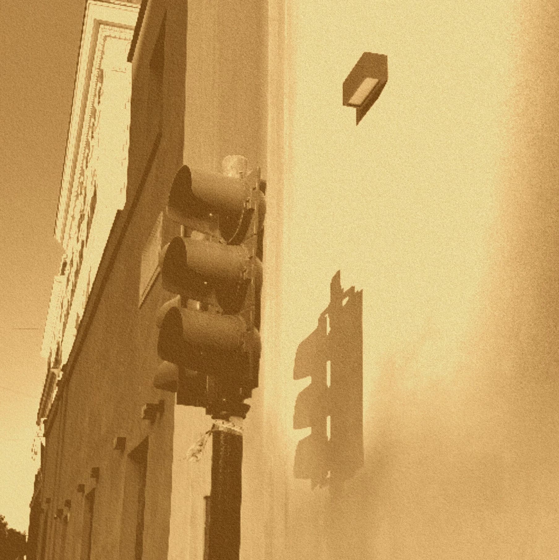 Sepia street facade with traffic lights.