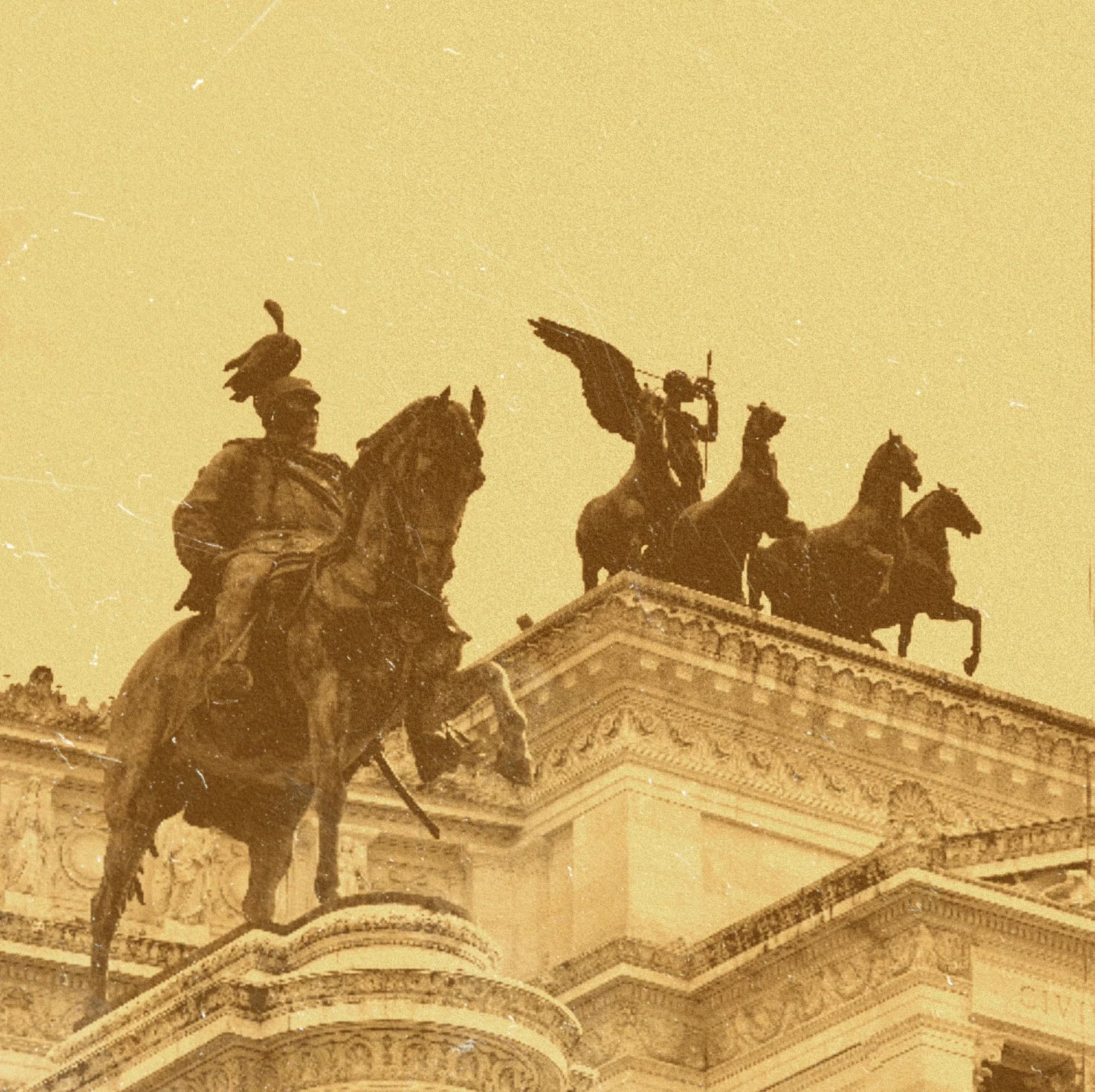 Sepia equestrian statues above a building.