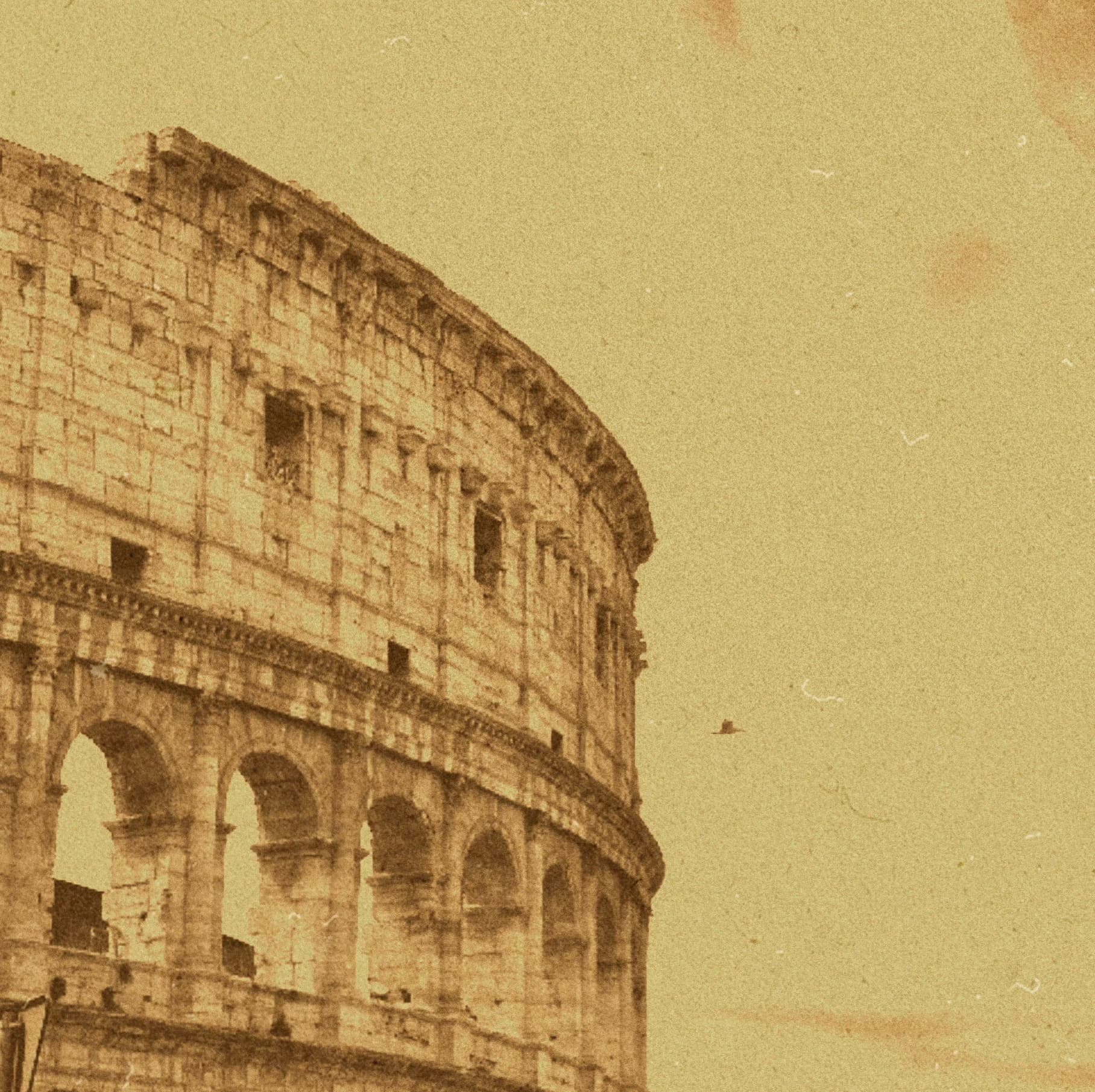 Sepia view of a curved, arched stone facade.