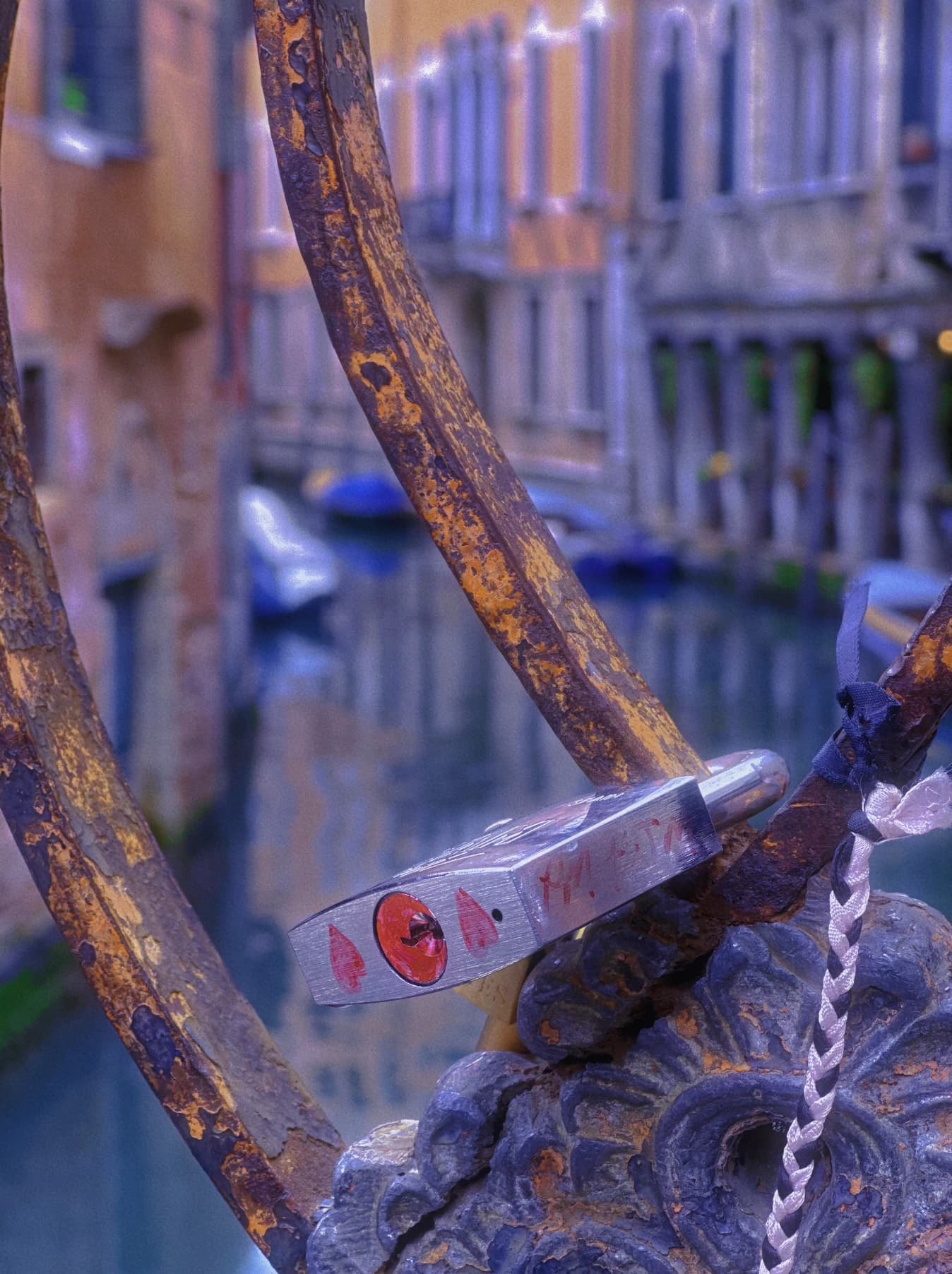 Close-up of metal railings beside a canal.