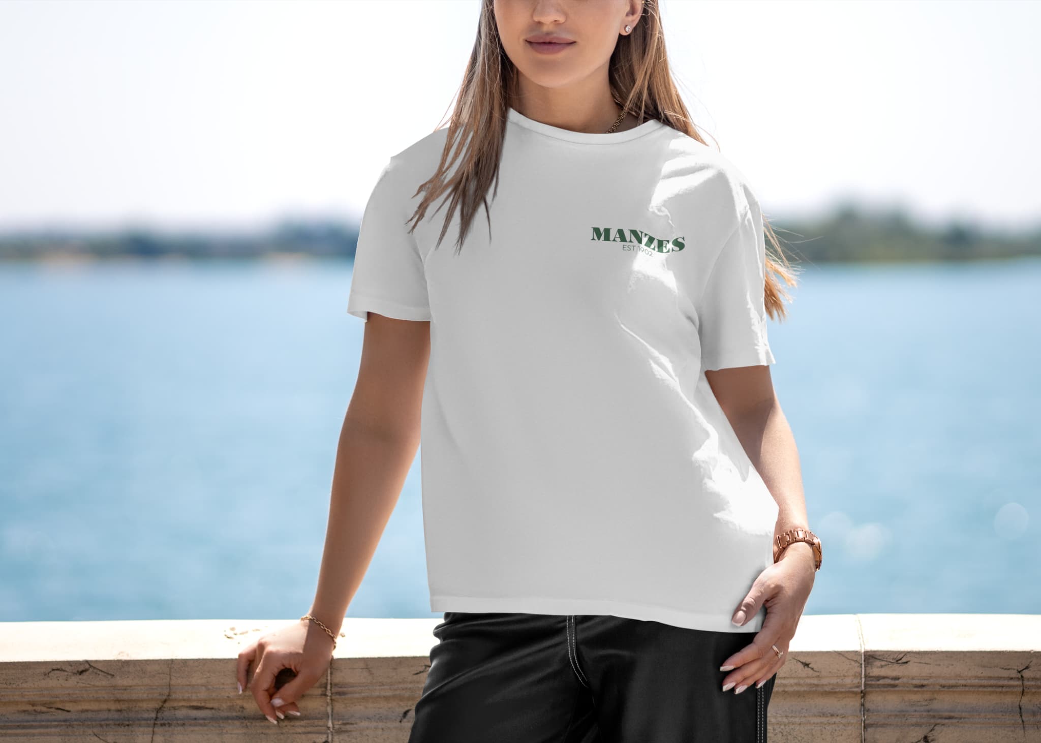 Supplied front T-shirt design presentation with a small green Manzes chest mark.